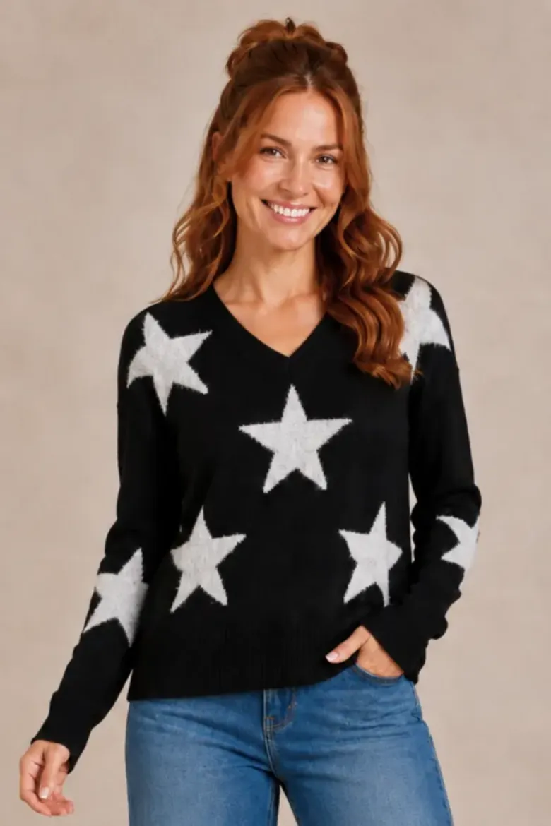 Close-up of the black V-neck sweater with oversized white jacquard stars