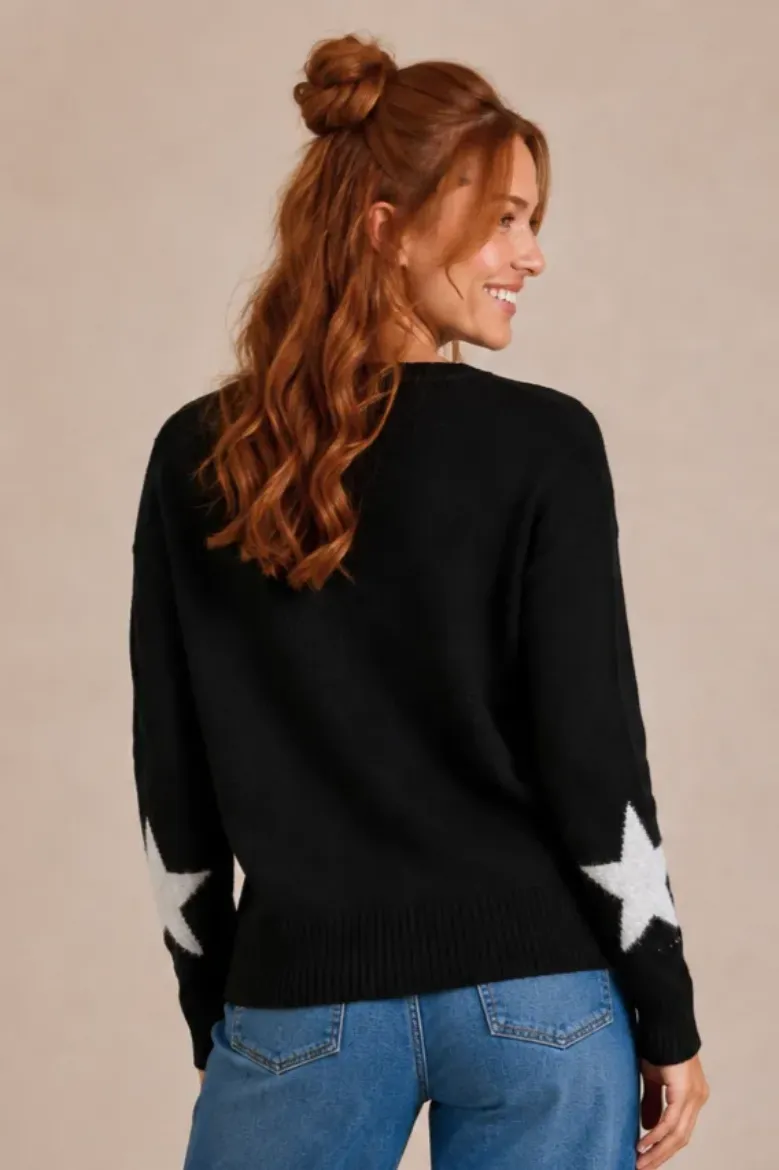 Back view of the black star sweater with stars on the sleeves