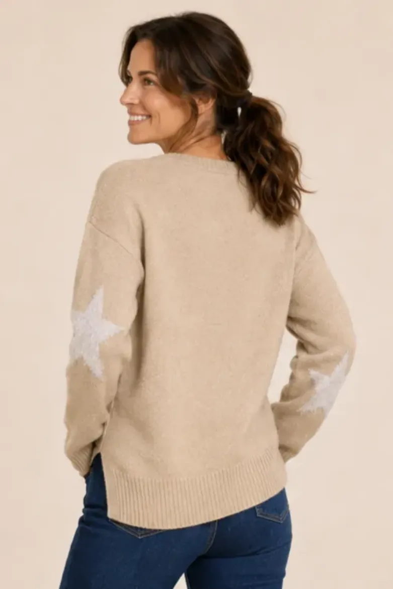 Back view of the oatmeal star sweater showing the hem vent and starred sleeve