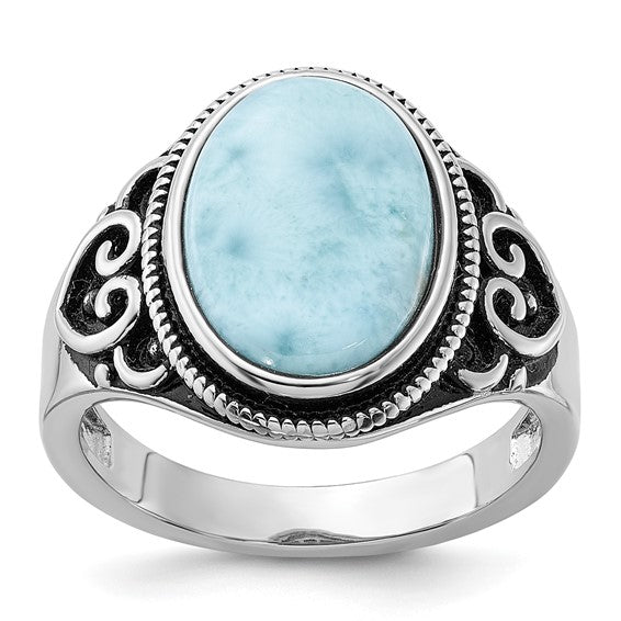 Oval larimar stone in an oxidized sterling silver ring with swirl filigree shoulders