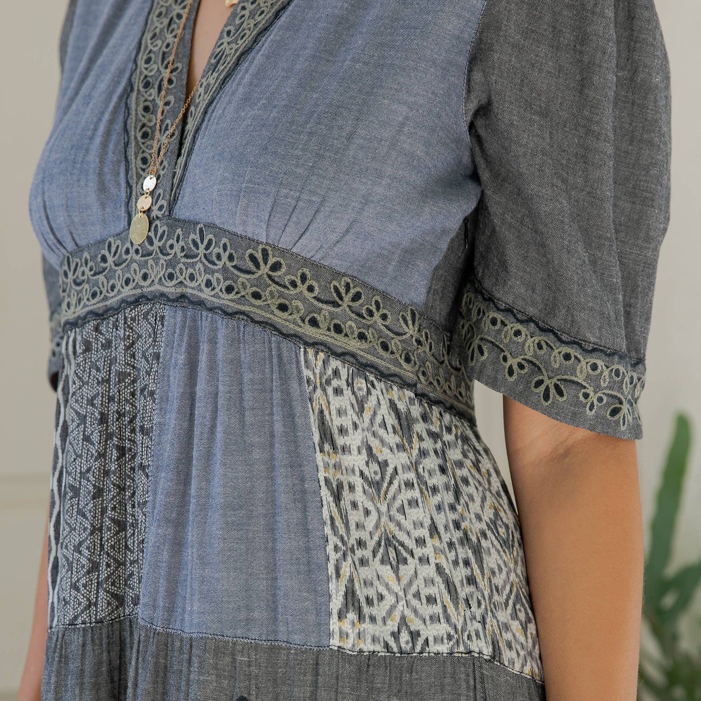 Close-up of the eyelet-trimmed empire band and mixed patchwork panels