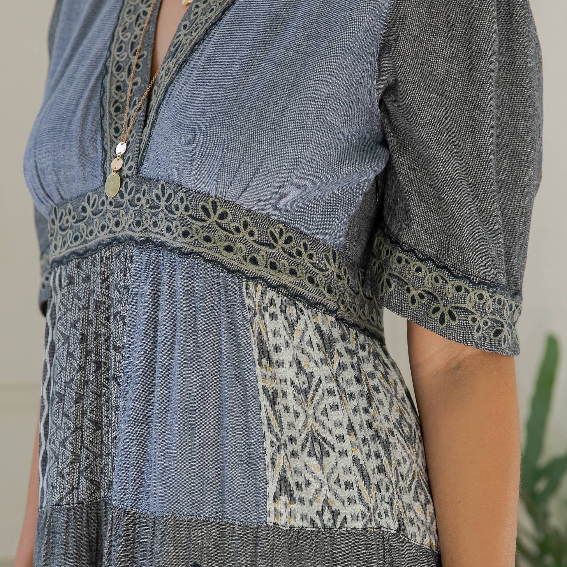 Close-up of the eyelet-trimmed empire band and mixed patchwork panels