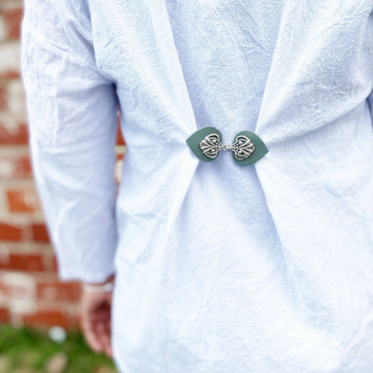 Back of a white blouse cinched with the sea green sweater clip