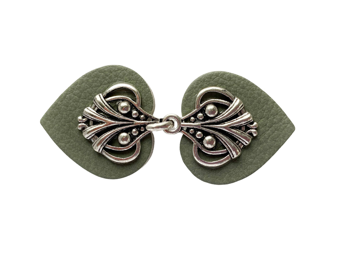 Sea green leather hearts with ornate silver filigree, clip closed, studio shot