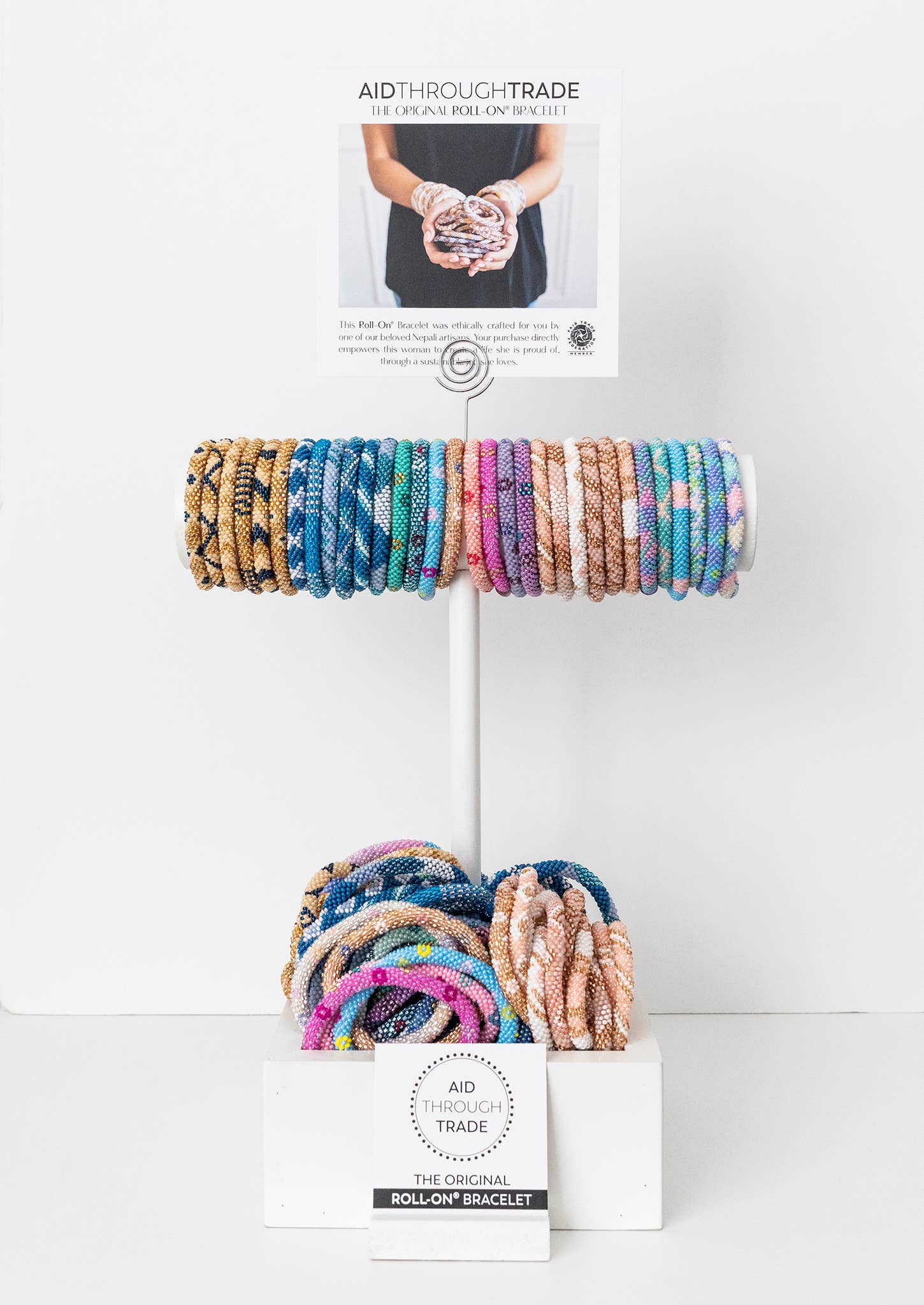 Countertop display stand stacked with assorted roll-on bracelets