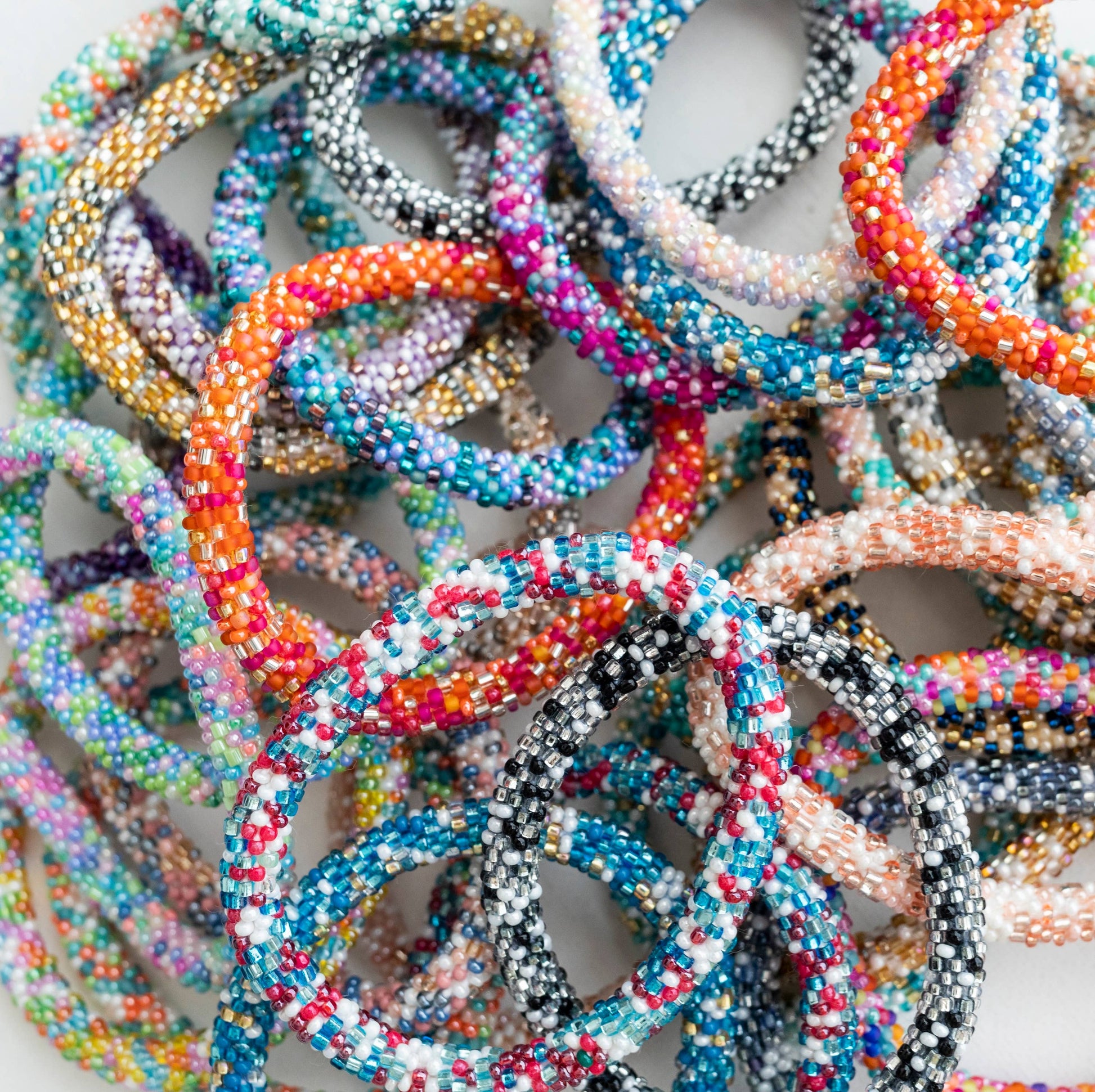 Overhead pile of bright multicolor roll-on bracelets