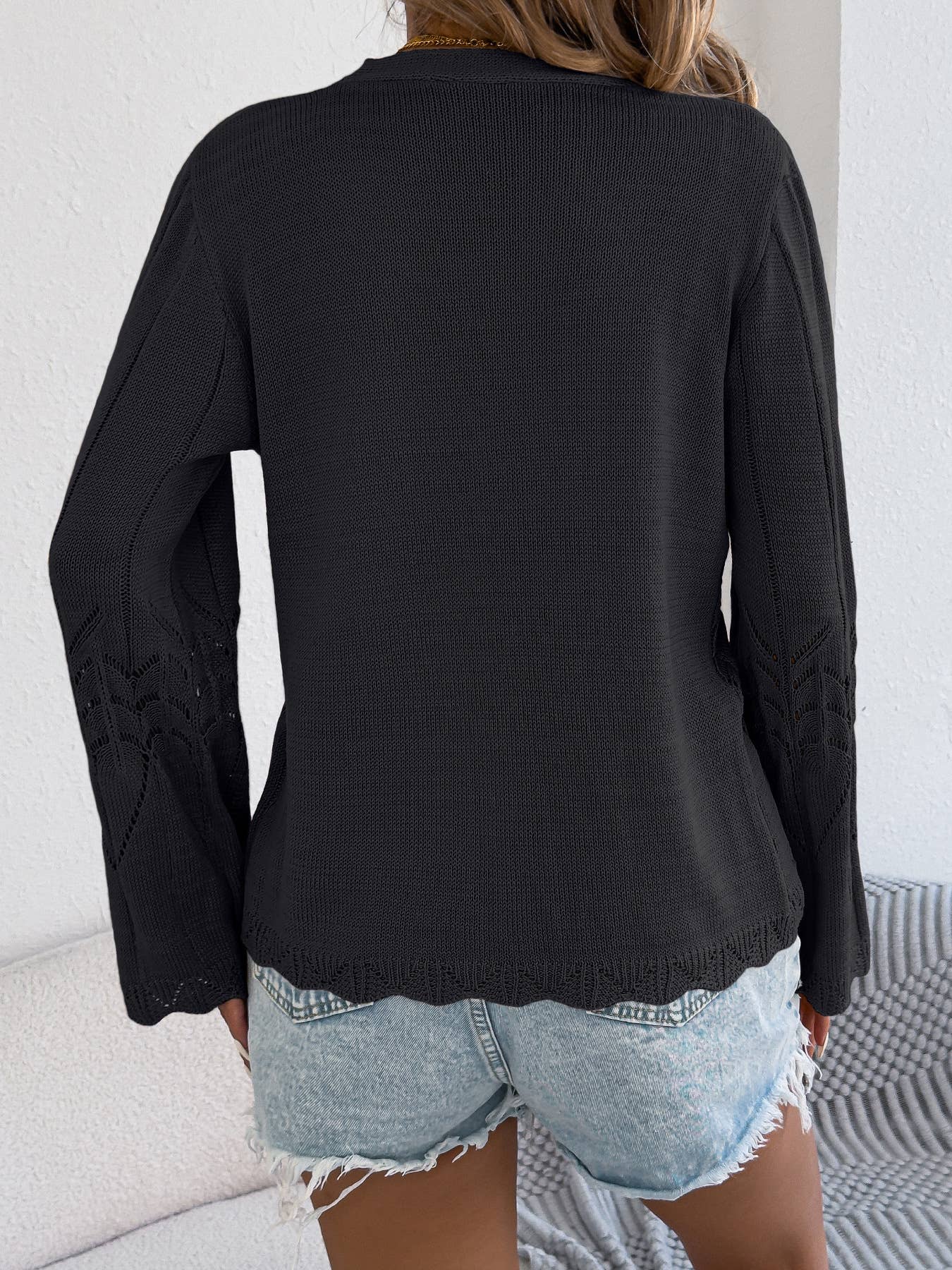 Back view of the black pointelle knit cardigan