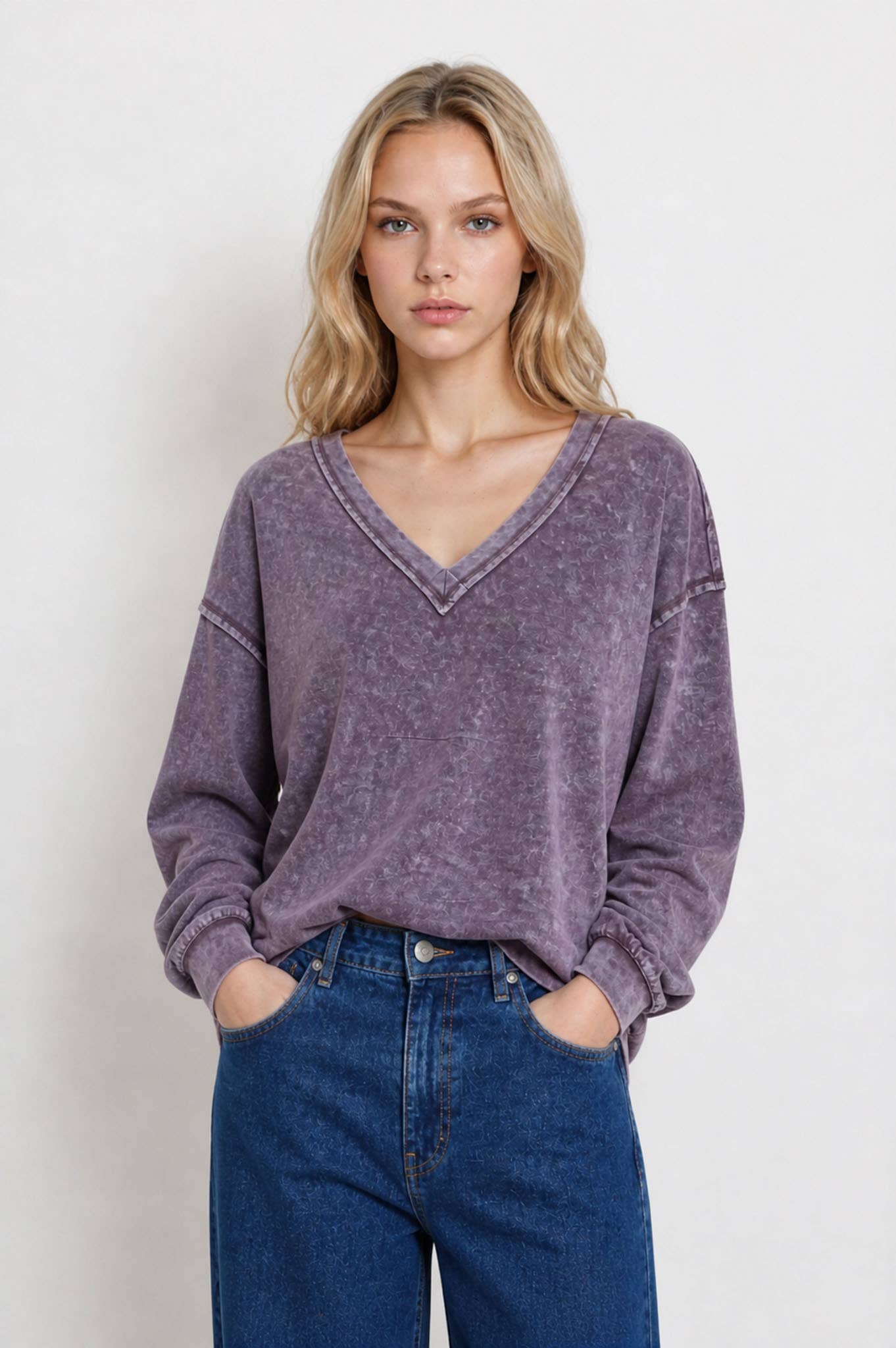 Front view of the eggplant washed V-neck knit top with balloon cuffs
