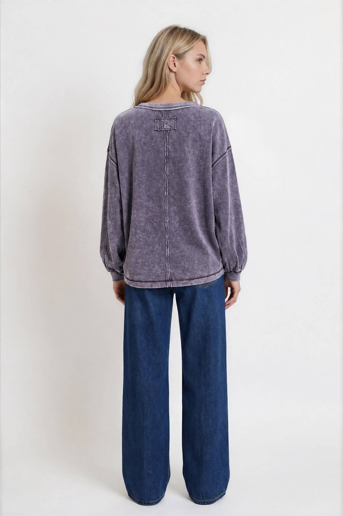 Full-length back view with dark jeans