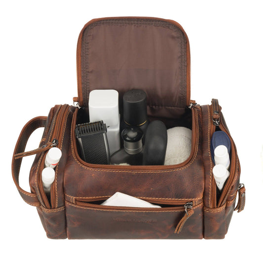Winston chestnut leather toiletry bag open with grooming items inside the wide-mouth main compartment