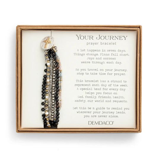 The black prayer bracelet mounted on its printed Demdaco Your Journey gift card