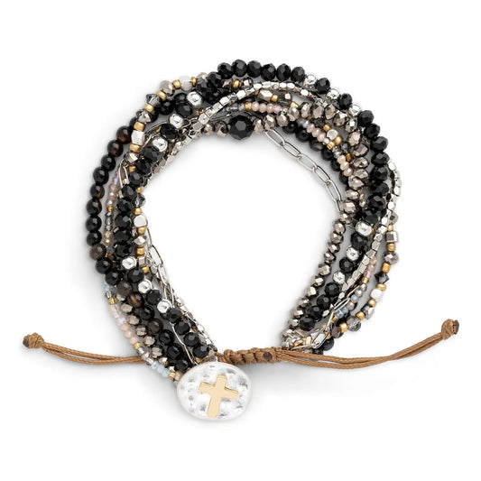 Your Journey prayer bracelet in black, charcoal and silver laid flat with a mother of pearl disc at the center