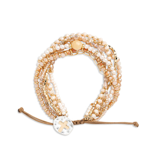 Your Journey prayer bracelet in champagne, cream and gold laid flat with pearl beads and a mother of pearl disc