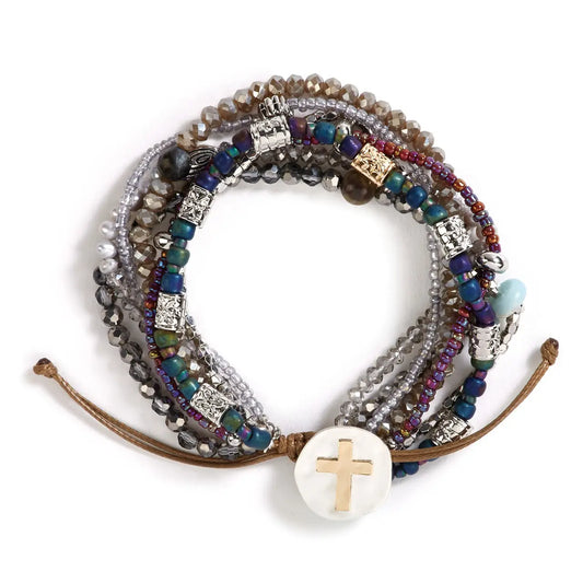 Your Journey prayer bracelet in gray, navy and muted plum laid flat with a mother of pearl cross disc and leather pull tie